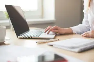 Laptop előtt dolgozó személy – koncentrált munkavégzés íróasztalnál